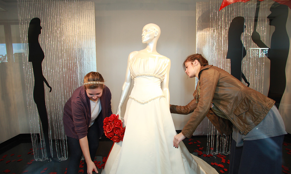 Fashion students working on a wedding dress display