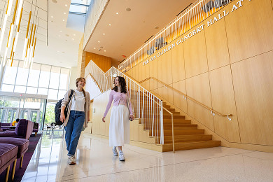 two students walking through the Van Cliburn concert hall atrium