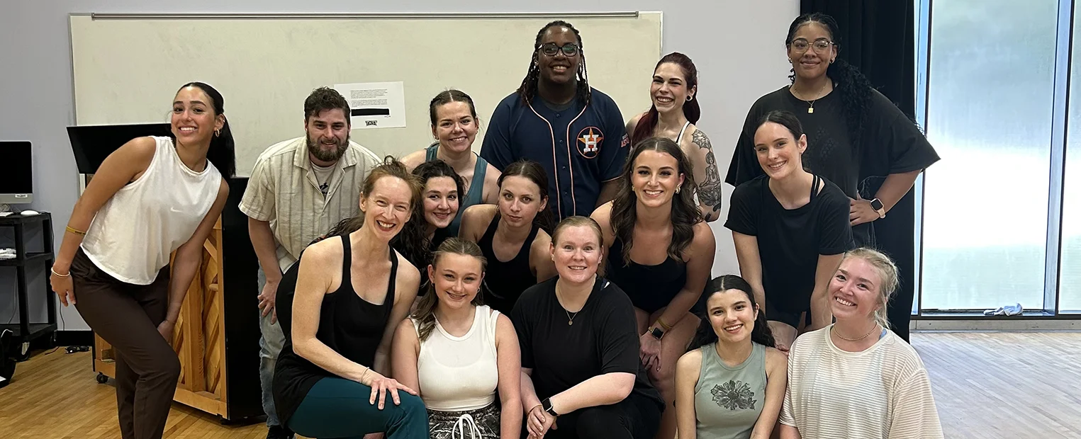 A group of dancers gather in the studio