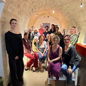 Suki John gathers with a group in a small screening room in Paris