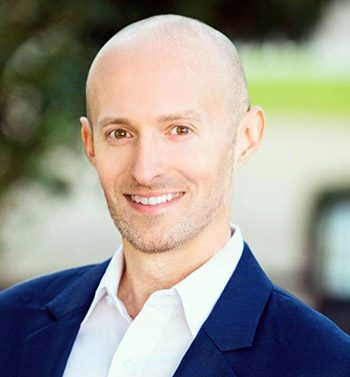 Corey Trahan, wearing a navy blue sport coat and white shirt