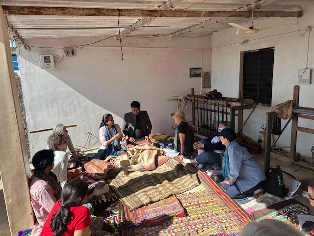 Weavers work while seated on the ground
