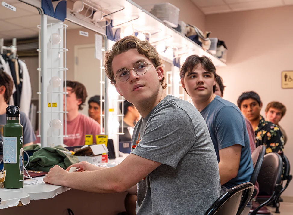 Actors prepare backstage for a dress rehearsal